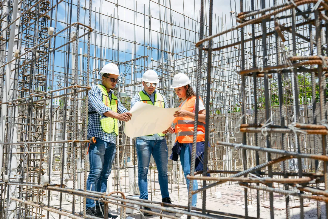 Construction professionals reviewing plans on site